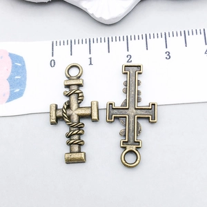 Macro view of vintage bronze alloy hollow cross pendants with scale measurement