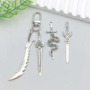 Detailed view of antique silver fantasy sword pendants with intricate weapon engravings