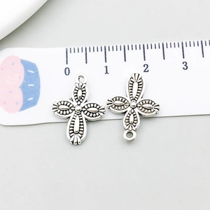 Macro detail of two antique silver cross pendants with floral texture for DIY jewelry