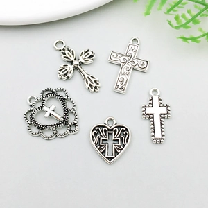 Collection of vintage silver alloy cross and heart charms for DIY jewelry making