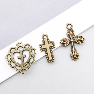 Close-up of vintage bronze hollow cross pendants for DIY jewelry making and crafts