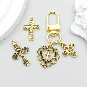 Macro detail of antique gold hollow heart cross pendants and religious jewelry charms