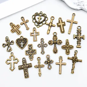 Macro shot of 17 vintage bronze alloy cross pendants with intricate hollow carvings