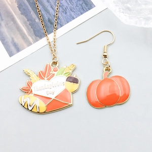 Macro detail of Thanksgiving series necklace and pumpkin earrings in colorful enamel finish