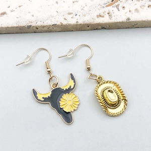 Detail of asymmetric cowboy hat and bull skull earrings with drip oil finish