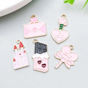 Detailed view of pink enamel heart charms set in gold finish for DIY jewelry making