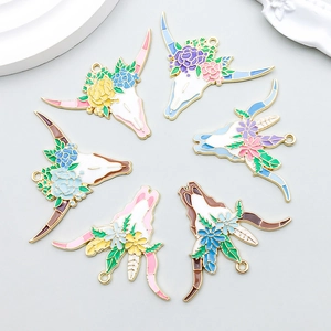 Detailed view of colorful enamel bull skull flower pendants for DIY jewelry making