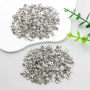 Macro detail of vintage silver alloy charms featuring ocean shells and marine life for DIY crafts