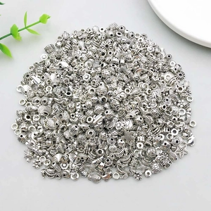 Close-up of mixed antique silver beads featuring sea life and floral charms for DIY jewelry