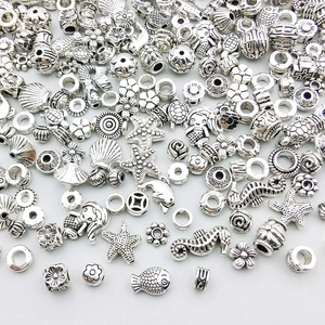 Macro view of assorted silver beads featuring starfish and seahorse for DIY jewelry