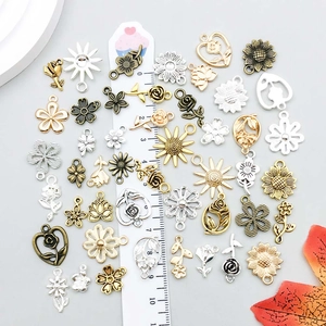Assorted alloy flower pendants in gold, silver, and bronze for DIY jewelry making
