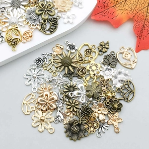 Macro detail of mixed alloy floral pendants in gold and silver for DIY jewelry crafting