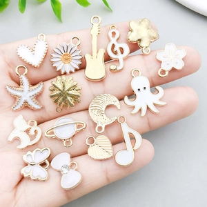 DIY gold alloy charms set featuring white enamel butterfly, starfish, and daisy pendants