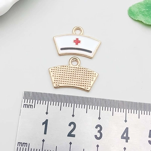 Detailed front and back of 18mm enamel nurse hat charm with red cross on ruler