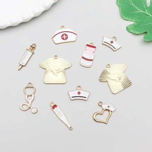 Macro view of medical-themed charms including nurse hats, stethoscope, and syringe