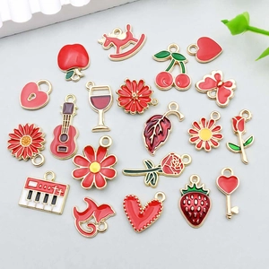 Macro shot of assorted red enamel sunflower and rose flower charms for DIY jewelry making