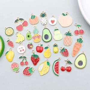 Detailed view of colorful fruit and vegetable enamel charms for DIY jewelry making