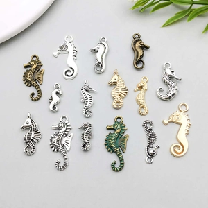 Detailed close-up of mixed alloy seahorse pendants in antique silver, gold and bronze finishes