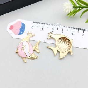 Detail showing front and back of pink fish alloy pendant with golden edges for jewelry DIY