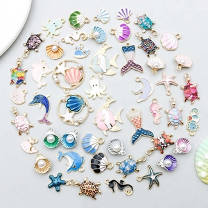 Detailed overhead view of colorful enamel ocean animal charms for DIY jewelry making