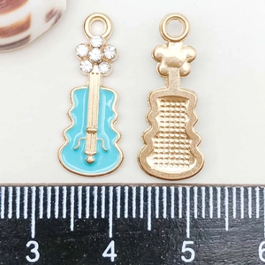 Detail of blue enamel violin pendant with tiny rhinestones and measurement ruler
