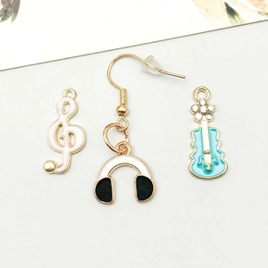 Detail of music charms with pink treble clef and blue guitar with rhinestones