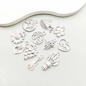 Detailed assortment of shiny silver alloy charms featuring tree of life and flowers