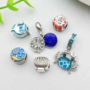 Detailed view of sea-themed alloy charms with blue enamel finish and zircon inlays