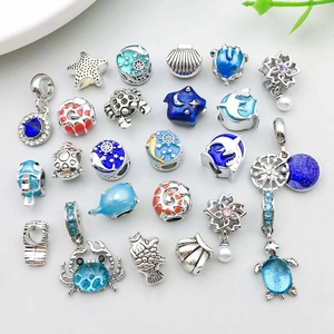 Collection of ocean themed alloy beads with starfish dolphin and sea turtle charms