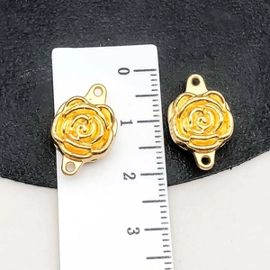 Detailed macro view of golden rose-shaped DIY jewelry connector with dual attachment rings