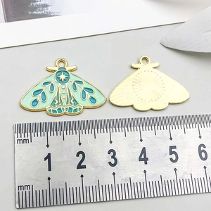 Detail view of colorful butterfly pendant with measurement ruler showing 35mm width size