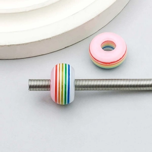 Macro detail of rainbow striped resin large hole beads for DIY jewelry making