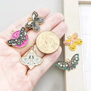 Colorful enamel butterfly pendants in five designs with 1 dollar coin for size reference
