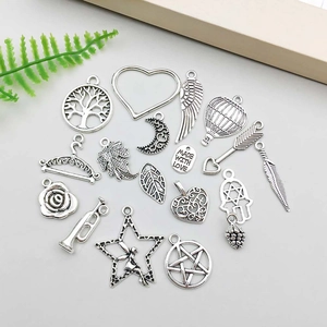 Detailed flat lay of assorted antique silver alloy charms for DIY jewelry making