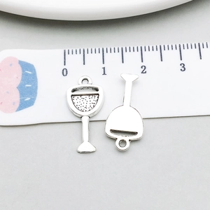 Macro detail of wine glass charms in antique silver with 20mm height scale reference