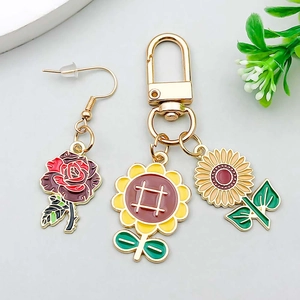 Detail of sunflower and rose pendants with colorful enamel oil drip alloy finish