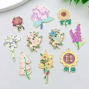 Collection of colorful enamel sunflower and lily pendants for DIY jewelry making and crafts