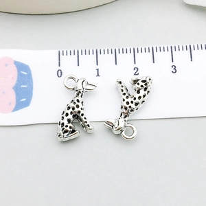 Detail of silver dalmatian dog charms with scale showing 2cm size for DIY jewelry