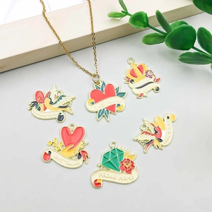 Detail of gold enamel Mother's Day charms featuring carnations and Mama text pendants