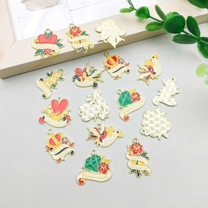 Detail view of colorful enamel Mother's Day charms featuring Best Mama and flower designs