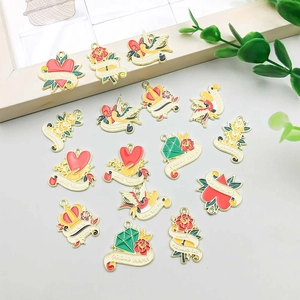 Detailed view of enamel heart and flower charms for Mother's Day DIY jewelry making