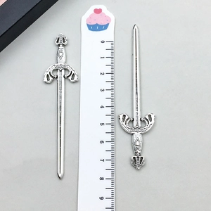 Detail of vintage silver sword pendant with Gladiator engraving and scale reference