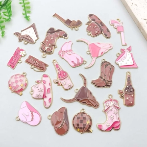 Detail of pink and brown enamel cowboy charms including bull heads and boots