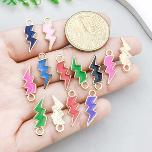 Colorful lightning bolt enamel charms for DIY jewelry making shown with a size reference