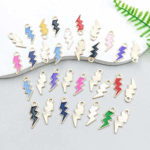 Close-up of colorful enamel lightning bolt pendants with gold plating for DIY jewelry