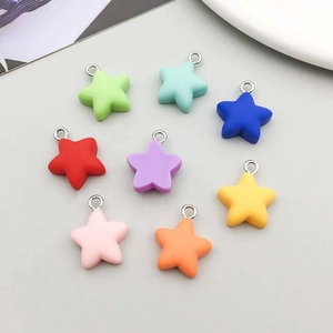 Close-up of eight colorful matte resin star pendants for DIY jewelry making