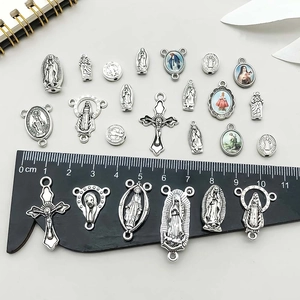 Assorted silver alloy religious cross and Virgin Mary charms with centimeter ruler scale