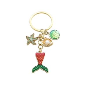 Porte-clés sirène vert avec étoile de mer, coquillage et perle sur finition dorée