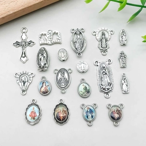 Detailed close-up of antique silver religious pendants including crosses and medals