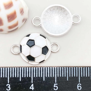 Detail of 2cm colorful enamel football charms with dual loops on a white background